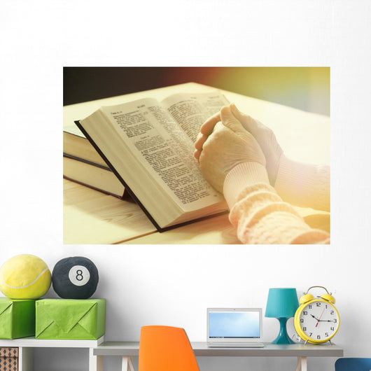 Hands of old woman with Bible on table Wall Mural
