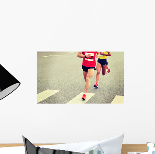 marathon runner legs running on city street Wall Mural