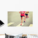 marathon runner legs running on city street Wall Mural