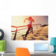 young fitness woman running on seaside stone stairs Wall Mural
