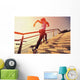 young fitness woman running on seaside stone stairs Wall Mural