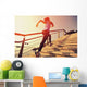 young fitness woman running on seaside stone stairs Wall Mural