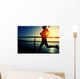 young fitness woman running on sunrise seaside boardwalk Wall Mural