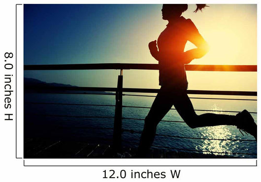 young fitness woman running on sunrise seaside boardwalk Wall Mural