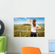 Athletic woman touching neck and back muscles by injury Wall Mural