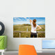 Athletic woman touching neck and back muscles by injury Wall Mural