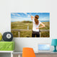 Athletic woman touching neck and back muscles by injury Wall Mural