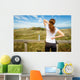 Athletic woman touching neck and back muscles by injury Wall Mural