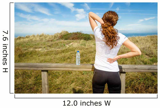 Athletic woman touching neck and back muscles by injury Wall Mural