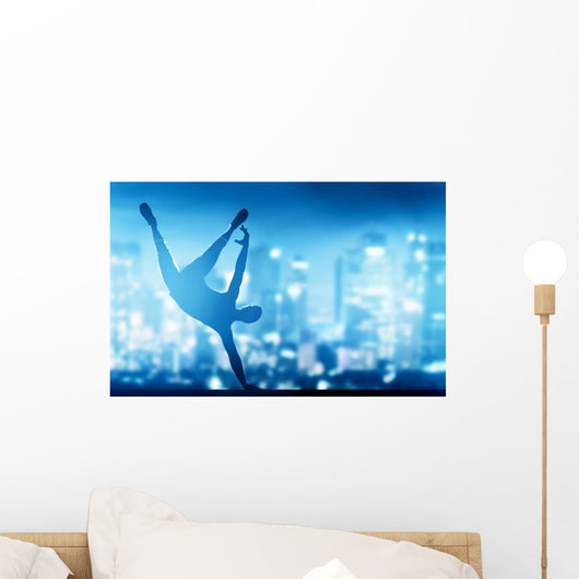 Hip hop, break dance performed by young man in city lights Wall Mural