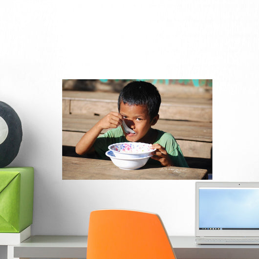 Child eating Wall Mural