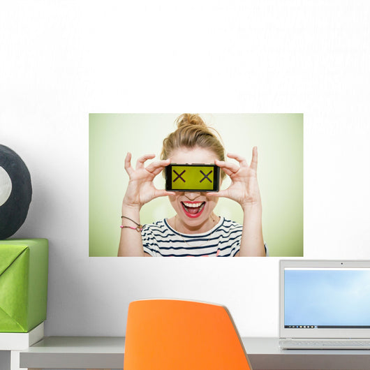 Woman with smartphone and crazy eyes Wall Mural