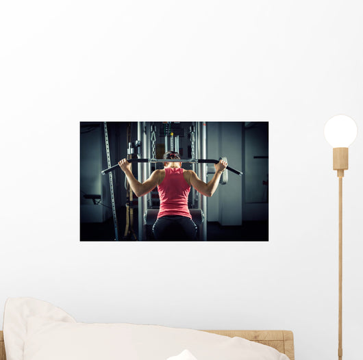 Sports background. Muscular fit woman exercising. Wall Mural