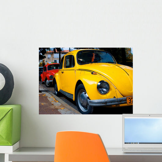 A Vintage Red and Yellow Volkswagen Beetle Parked Wall Mural