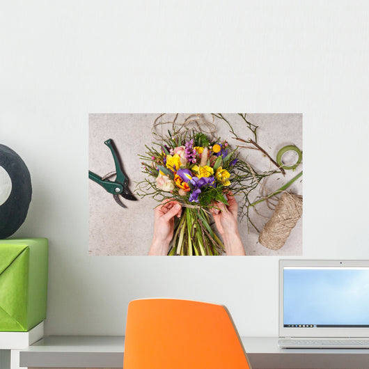 hands of florist making bouquet spring flowers Wall Mural