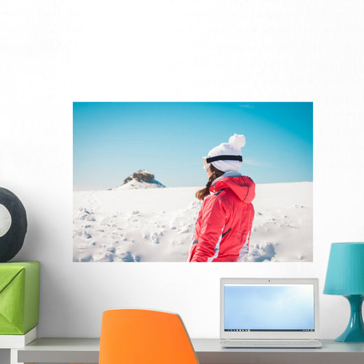Woman explorer skier looking the snowy horizon Wall Mural