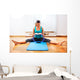 Fitness teacher making exercisese with the circle tool Wall Mural