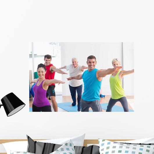 People doing warrior pose in yoga class Wall Decal