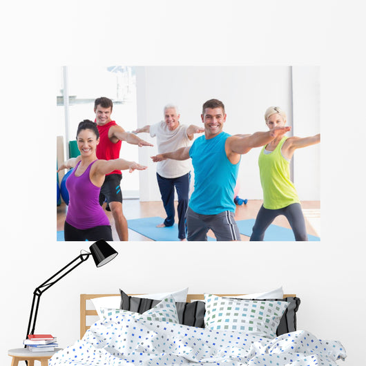 People doing warrior pose in yoga class Wall Decal