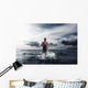 Young woman athlete running out of water Wall Mural