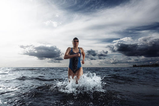 Young Woman Athlete Running Out Of Water Wall Decal