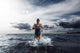 Young Woman Athlete Running Out Of Water Wall Decal
