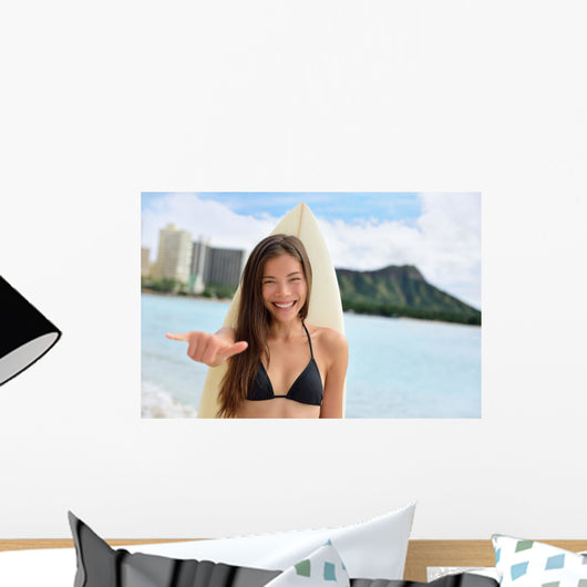 Surfer girl surfing showing mahalo shaka hand sign Wall Mural