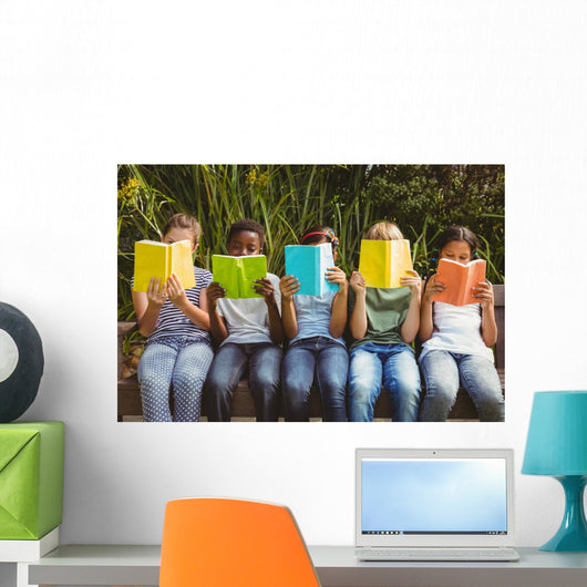 Children reading books at park Wall Mural