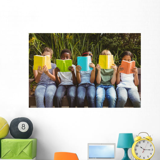 Children reading books at park Wall Mural