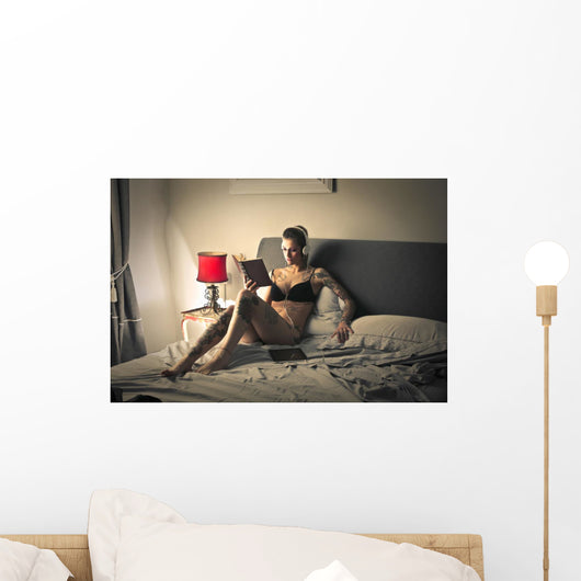 Tattooed girl reading Wall Mural
