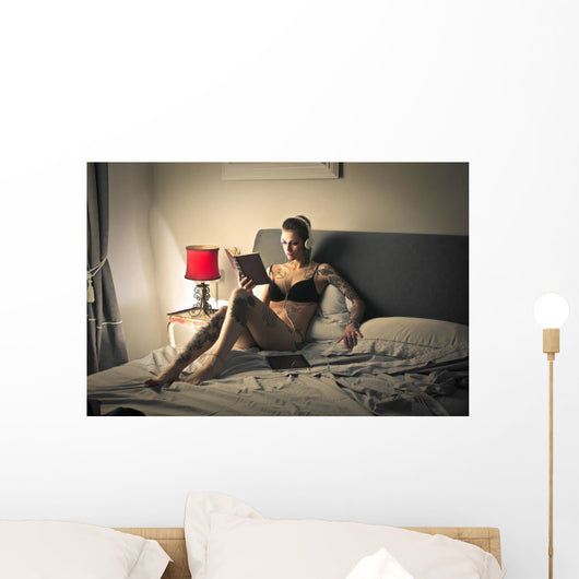 Tattooed girl reading Wall Mural