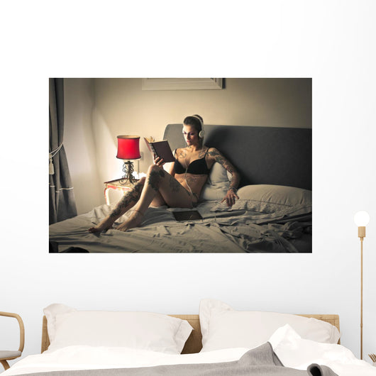 Tattooed girl reading Wall Mural