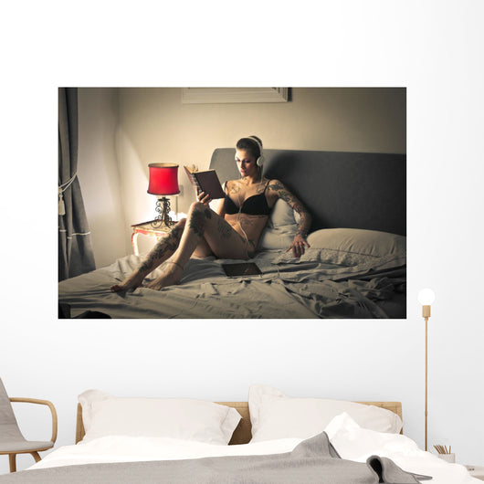 Tattooed girl reading Wall Mural