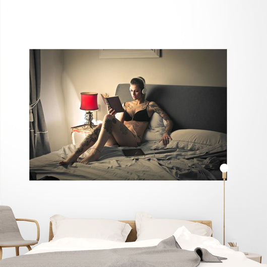 Tattooed girl reading Wall Mural