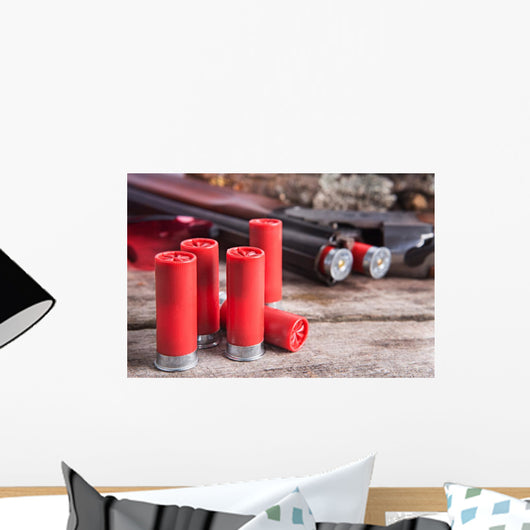 12 gauge shotgun shells with shotgun on wood surface Wall Mural