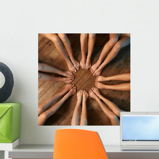 feet of dancers seated circle on floor Wall Mural