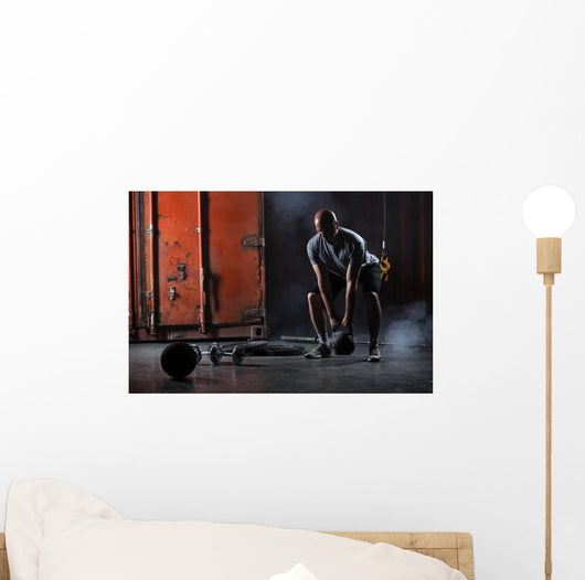 Bald charismatic athlete doing squats with weights. Wall Mural