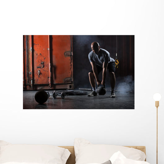 Bald charismatic athlete doing squats with weights. Wall Mural