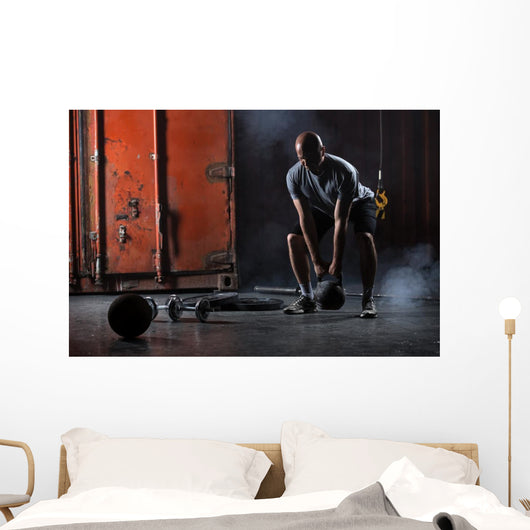 Bald charismatic athlete doing squats with weights. Wall Mural