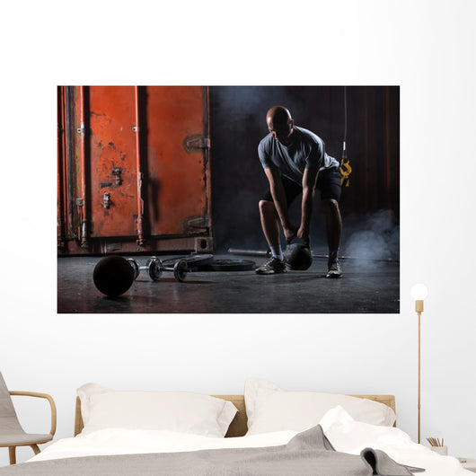 Bald charismatic athlete doing squats with weights. Wall Mural