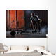 Bald charismatic athlete doing squats with weights. Wall Mural