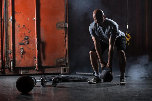 Bald Charismatic Athlete Doing Squats With Weights. Wall Decal