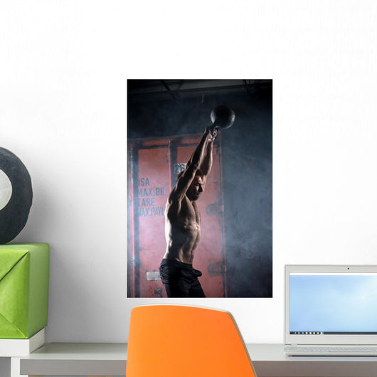 Beautiful athlete doing kettlebell swings. Profile picture. Athl Wall Mural