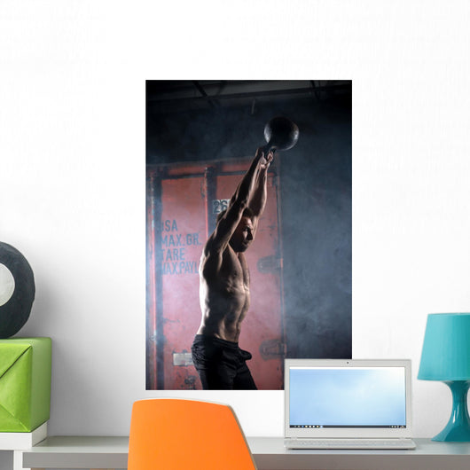 Beautiful athlete doing kettlebell swings. Profile picture. Athl Wall Mural