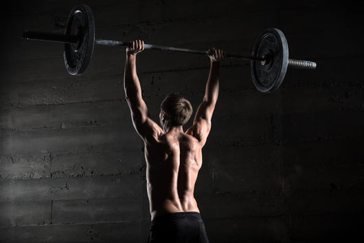 Portrait Of A Handsome Athlete From Behind. Athlete Raises The B Wall Decal