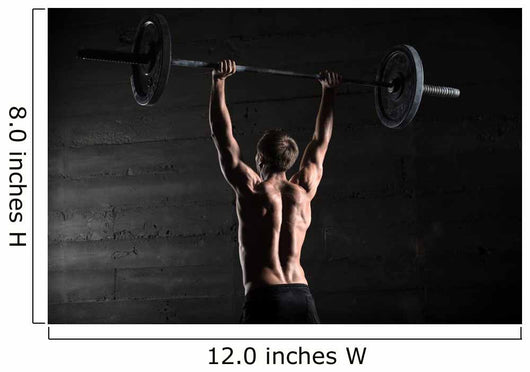 Portrait of a handsome athlete from behind. Athlete raises the b Wall Mural