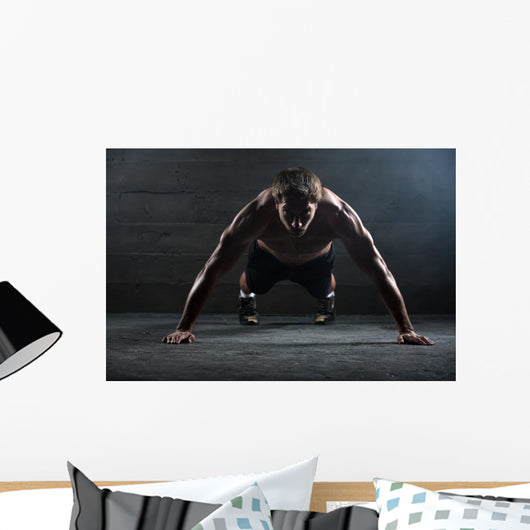 Athlete with a beautiful body and naked torso Wall Mural