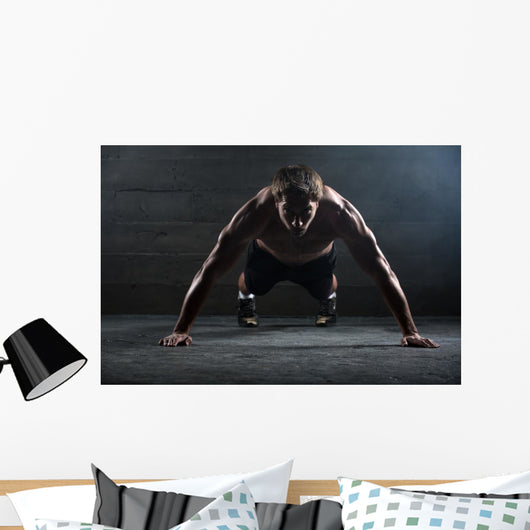 Athlete with a beautiful body and naked torso Wall Mural