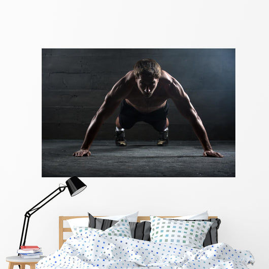 Athlete with a beautiful body and naked torso Wall Mural