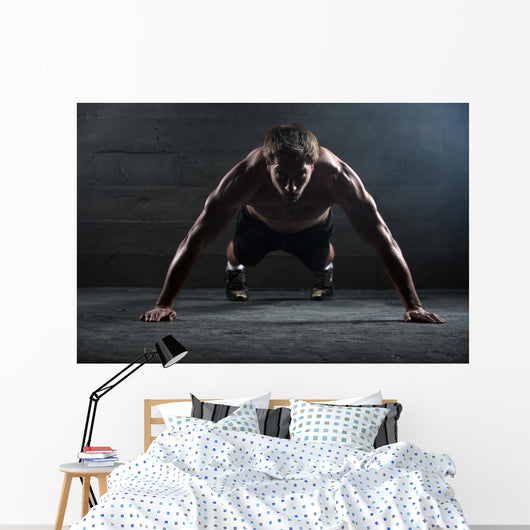 Athlete with a beautiful body and naked torso Wall Mural
